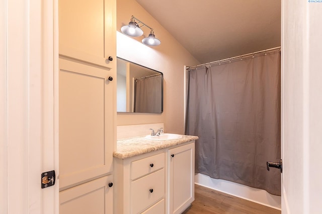 2001 Whelan Rd, Pullman, WA 99163 - full bathroom featuring vaulted ceiling, shower / bath combination with curtain, wood finished floors, and vanity