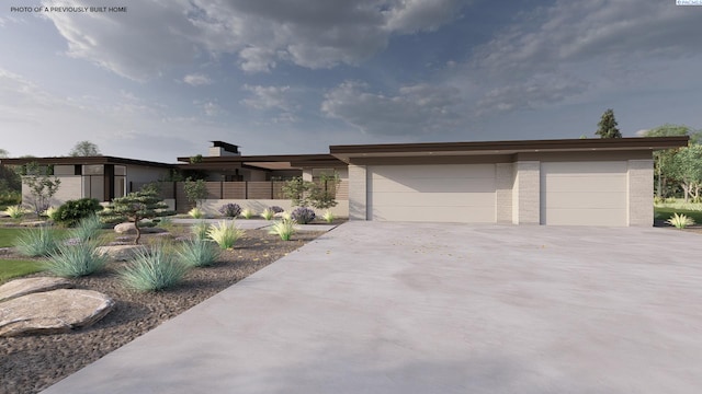 view of front facade featuring concrete driveway, brick siding, and a garage