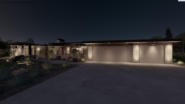 view of front facade with concrete driveway and a garage
