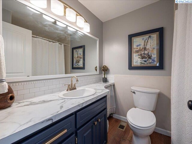 1842 Mahan Ave, Richland, WA 99354 - bathroom featuring vanity, wood finished floors, visible vents, baseboards, and toilet