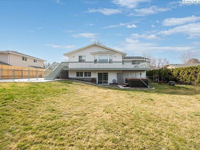 1842 Mahan Ave, Richland, WA 99354 - rear view of house with a patio, a wooden deck, a hot tub, stairs, and a lawn