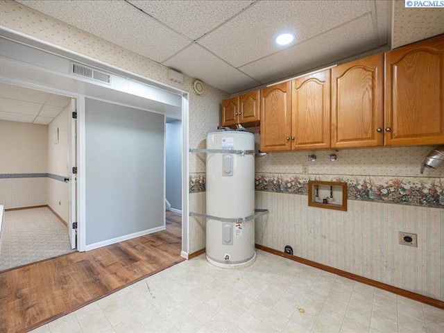 1842 Mahan Ave, Richland, WA 99354 - finished basement with wallpapered walls, strapped water heater, a paneled ceiling, and visible vents