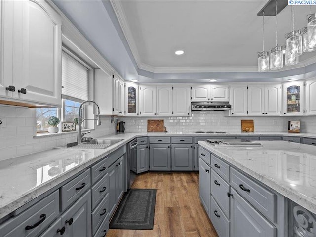 1842 Mahan Ave, Richland, WA 99354 - kitchen featuring under cabinet range hood, ornamental molding, gray cabinets, white cabinets, and a sink