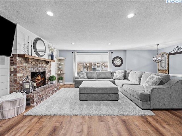 1842 Mahan Ave, Richland, WA 99354 - living area with recessed lighting, a fireplace, a textured ceiling, and wood finished floors
