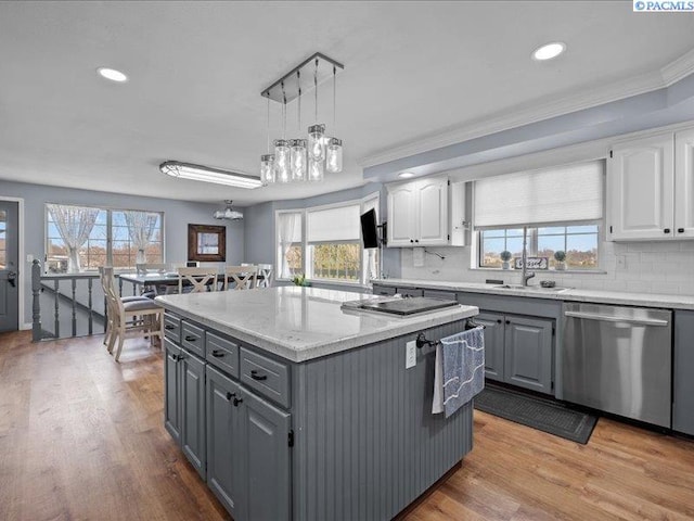 1842 Mahan Ave, Richland, WA 99354 - kitchen featuring light wood finished floors, stainless steel dishwasher, gray cabinets, and white cabinetry