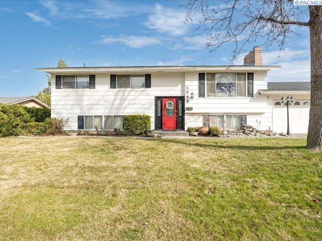 1842 Mahan Ave, Richland, WA 99354 - split foyer home featuring a garage, a chimney, and a front lawn