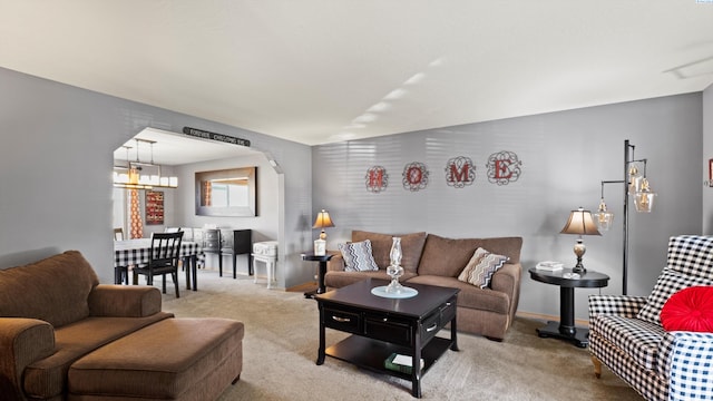 4504 S Dayton Ct, Kennewick, WA 99337 - carpeted living area with baseboards and a chandelier