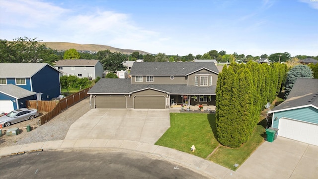 4504 S Dayton Ct, Kennewick, WA 99337 - traditional-style house featuring concrete driveway, a residential view, a garage, a mountain view, and roof with shingles