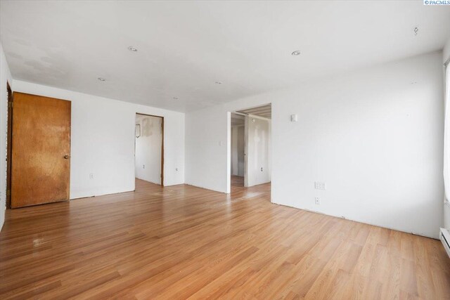 807 Snow, Richland, WA 99352 - empty room featuring light wood-style floors and a baseboard radiator