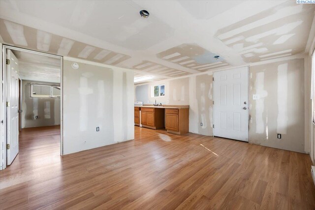 807 Snow, Richland, WA 99352 - unfurnished living room featuring light wood-style floors and a sink