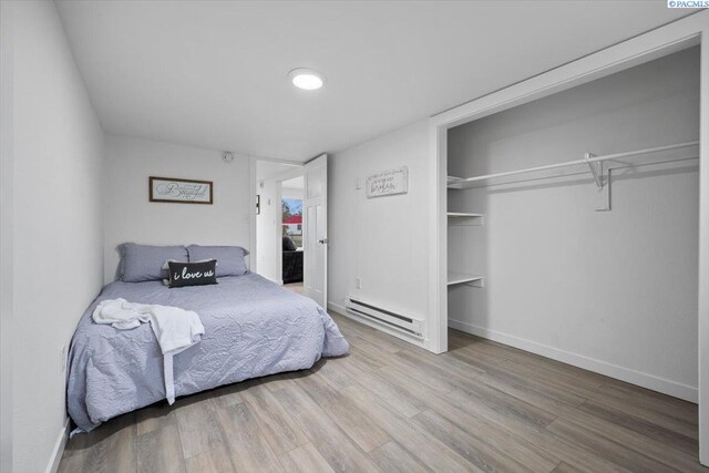 807 Snow, Richland, WA 99352 - bedroom with baseboard heating, wood finished floors, and a closet