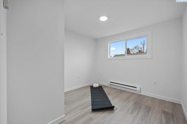 807 Snow, Richland, WA 99352 - spare room featuring a baseboard heating unit and light wood-type flooring