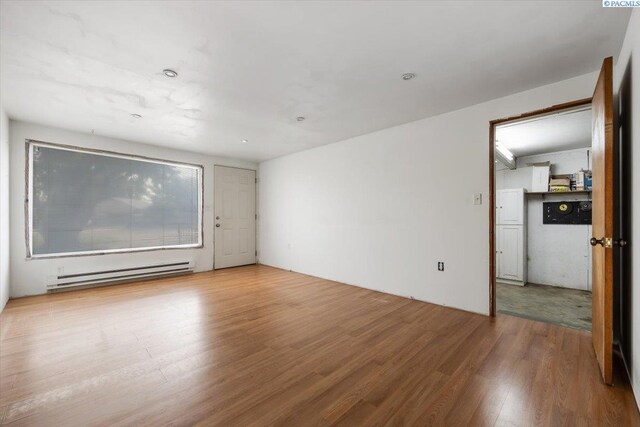 807 Snow, Richland, WA 99352 - spare room featuring a baseboard radiator and wood finished floors