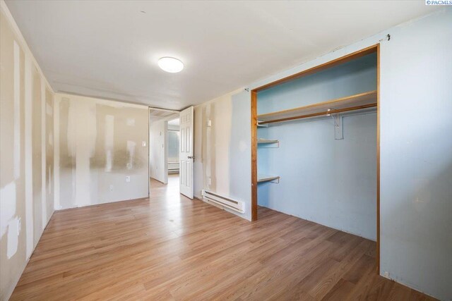 807 Snow, Richland, WA 99352 - unfurnished bedroom with a baseboard radiator, light wood-style floors, and a closet