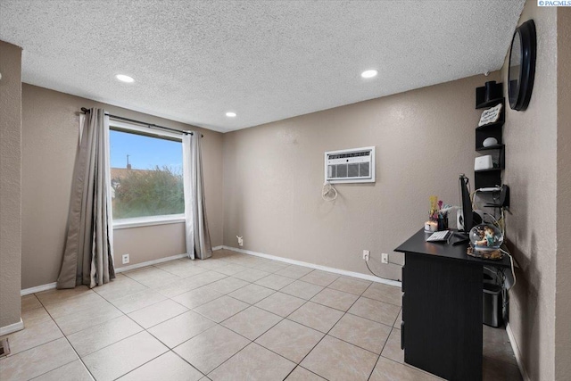 interior space featuring light tile patterned flooring, a textured ceiling, and an AC wall unit