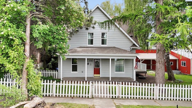 436 N Washington St, Tekoa, WA 99033 - view of front of house featuring a porch, roof with shingles, and a fenced front yard