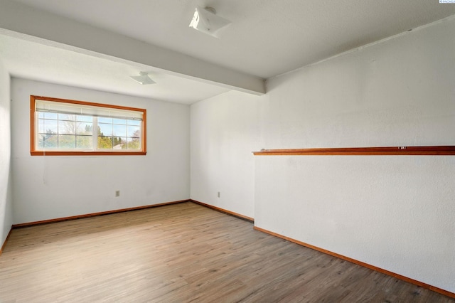 1584 Cimarron Ave, Richland, WA 99352 - empty room featuring wood finished floors, beamed ceiling, and baseboards
