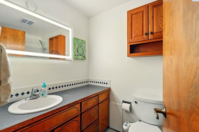 1584 Cimarron Ave, Richland, WA 99352 - full bathroom featuring toilet, vanity, visible vents, and a shower