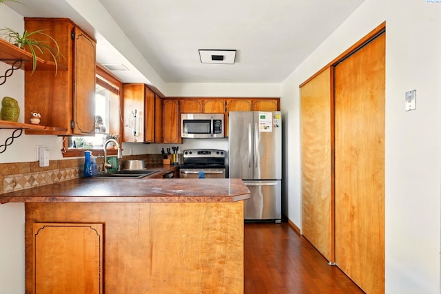 1584 Cimarron Ave, Richland, WA 99352 - kitchen with brown cabinetry, a peninsula, open shelves, a sink, and stainless steel appliances