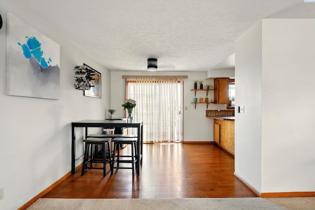 1584 Cimarron Ave, Richland, WA 99352 - dining area with a textured ceiling, wood finished floors, and baseboards