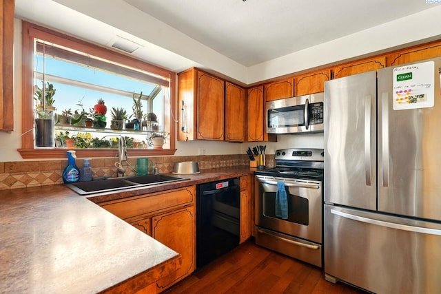 1584 Cimarron Ave, Richland, WA 99352 - kitchen with a sink, brown cabinetry, dark wood-style floors, and stainless steel appliances