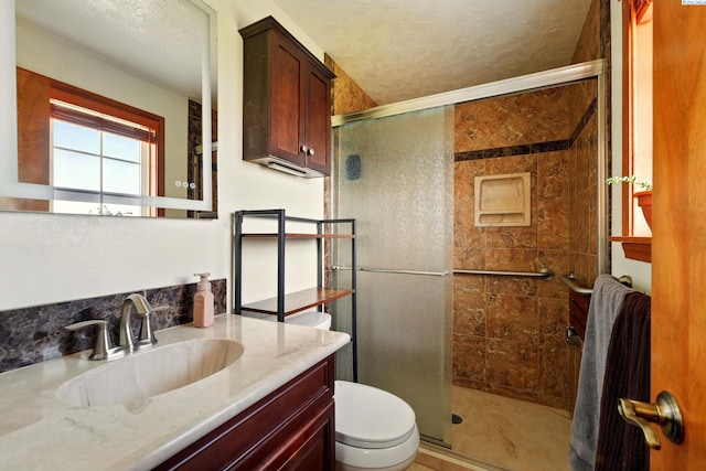 1584 Cimarron Ave, Richland, WA 99352 - full bathroom with a shower stall, vanity, a textured ceiling, and toilet