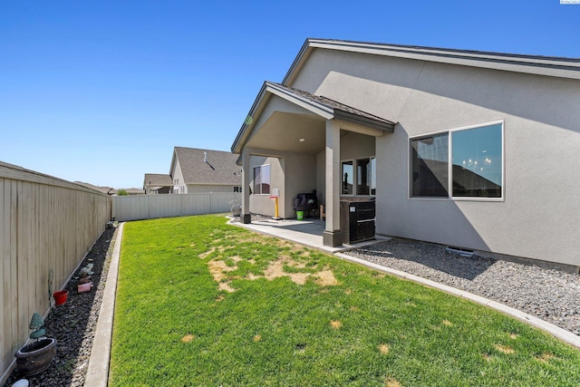 view of yard featuring a patio area and a fenced backyard