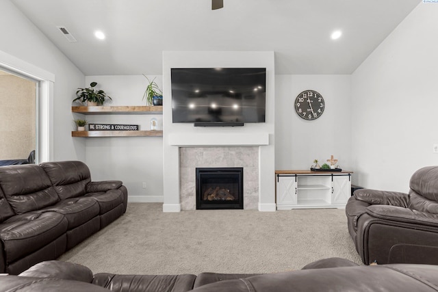 carpeted living area featuring visible vents, recessed lighting, ceiling fan, baseboards, and a tile fireplace