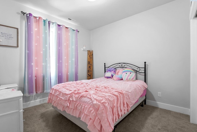 carpeted bedroom featuring baseboards and visible vents