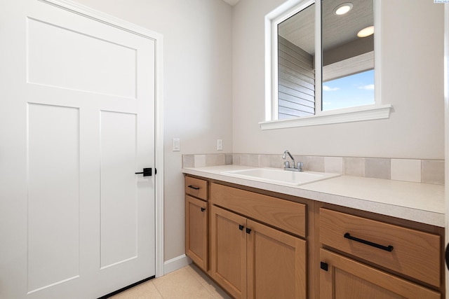 bathroom with tile patterned flooring and vanity