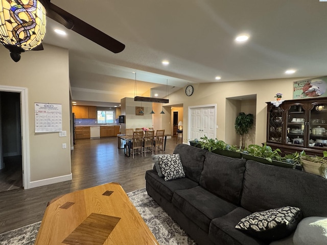 living area with recessed lighting, baseboards, dark wood-type flooring, and lofted ceiling