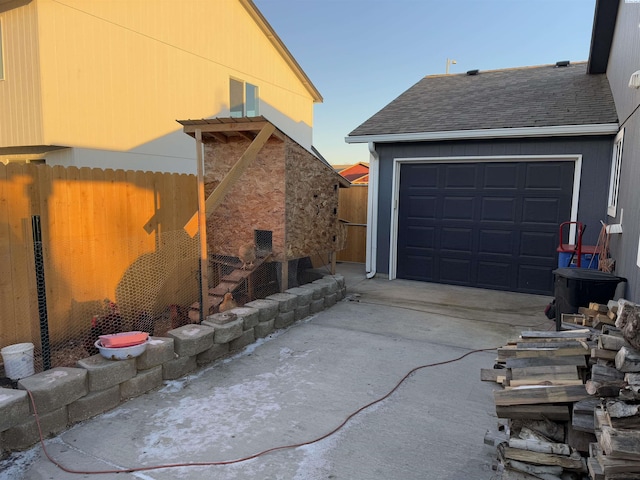 garage with driveway and fence