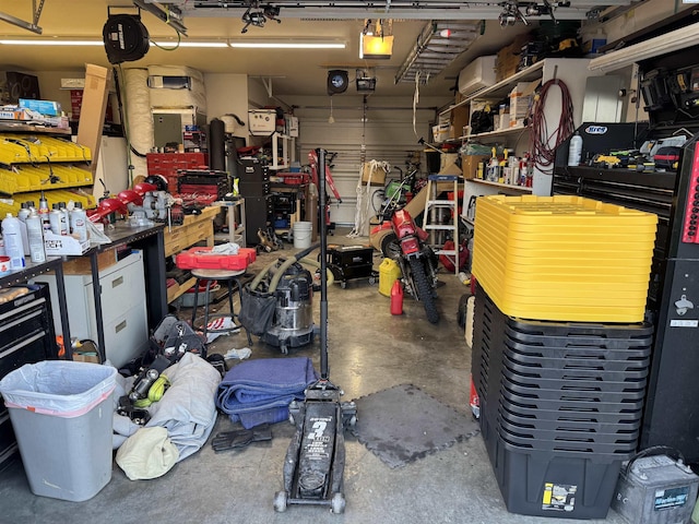 garage with a workshop area and a garage door opener