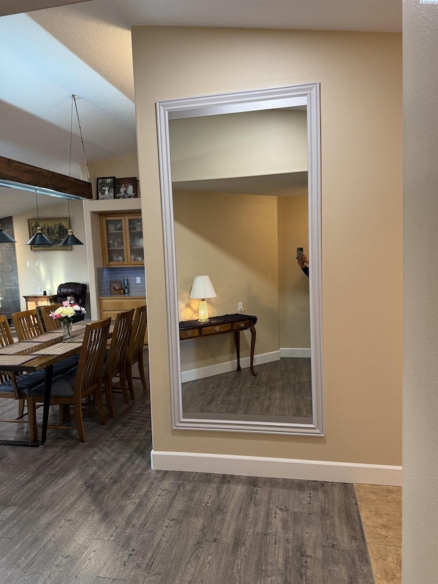 interior space with baseboards and wood finished floors