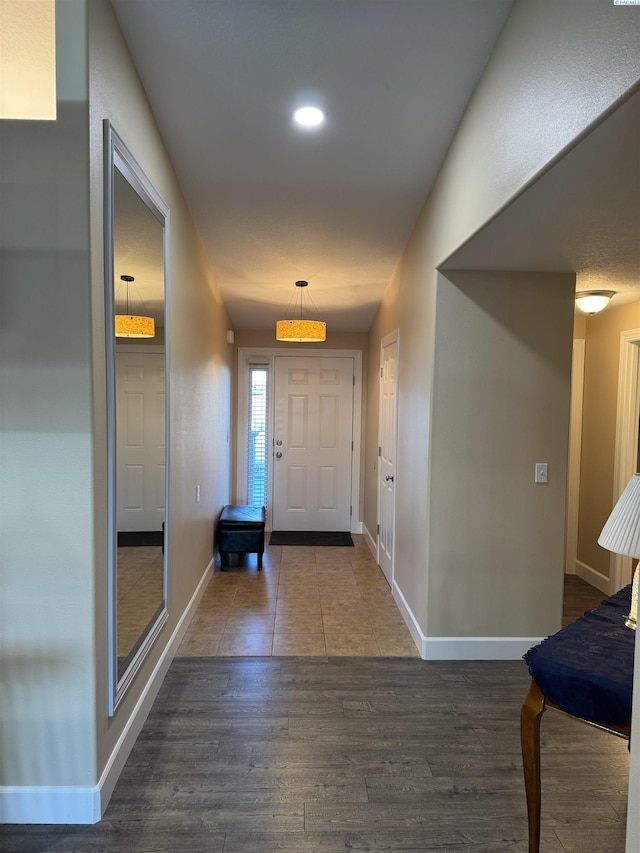 interior space featuring baseboards and wood finished floors