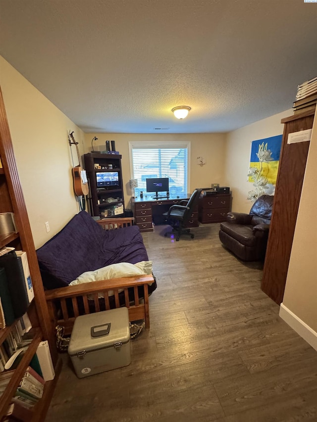 living room featuring a textured ceiling and wood finished floors