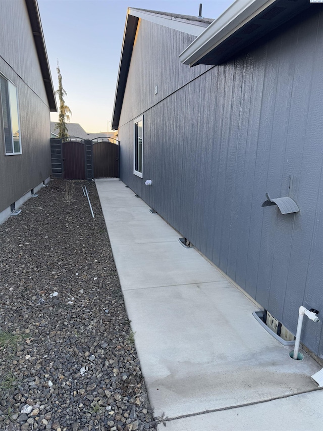 view of side of property featuring a gate