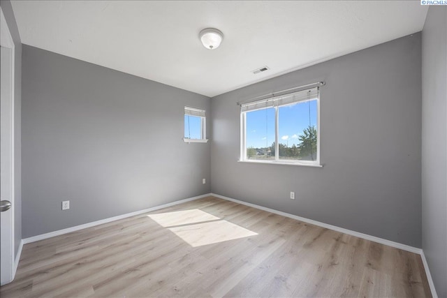 empty room featuring wood finished floors and baseboards