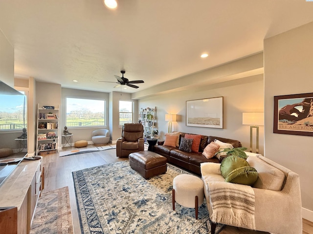 living area with a ceiling fan, recessed lighting, and wood finished floors