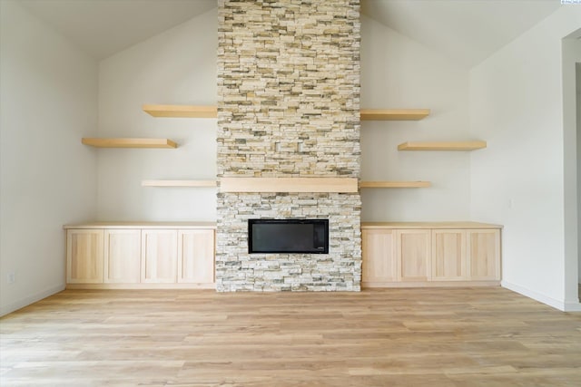 11812 Tschirky Ct, Pasco, WA 99301 - unfurnished living room with lofted ceiling, light wood-type flooring, baseboards, and a stone fireplace