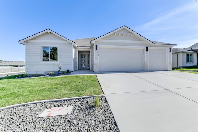 ranch-style home featuring stone siding, roof with shingles, concrete driveway, a front lawn, and a garage