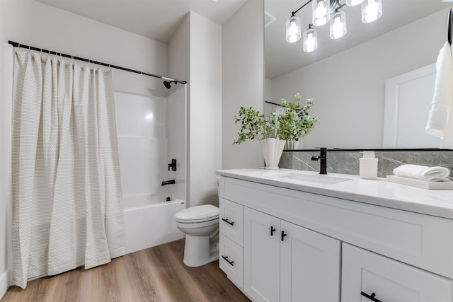 full bathroom with toilet, shower / bath combination with curtain, wood finished floors, and vanity