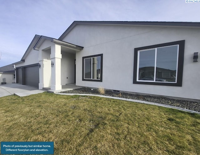 modern home featuring a garage and a front lawn