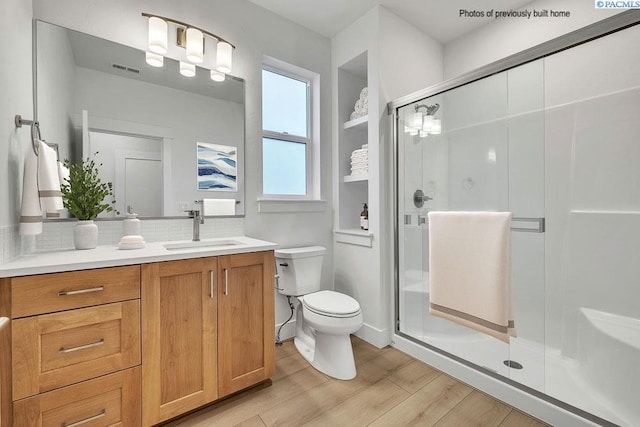 2781 Avrio Ave, Richland, WA 99354 - bathroom with toilet, wood finished floors, vanity, and a stall shower