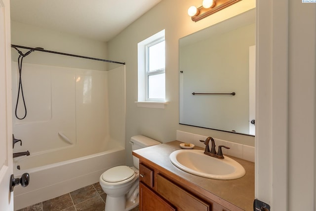 full bathroom featuring vanity, bathtub / shower combination, and toilet