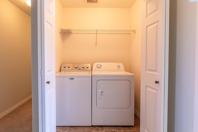laundry area featuring baseboards, laundry area, and washer and clothes dryer