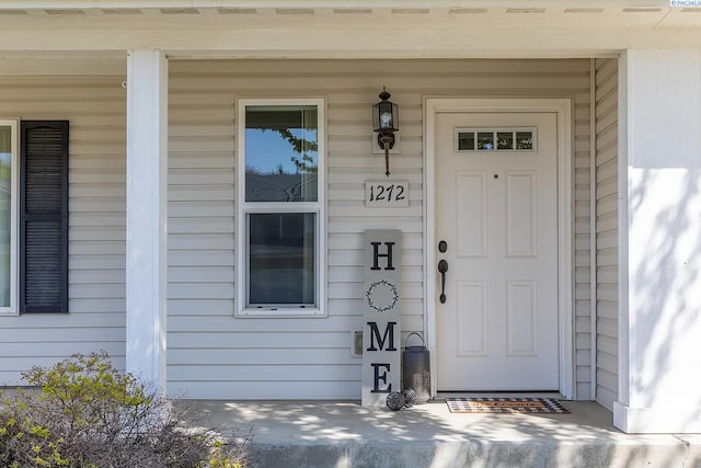 doorway to property featuring covered porch