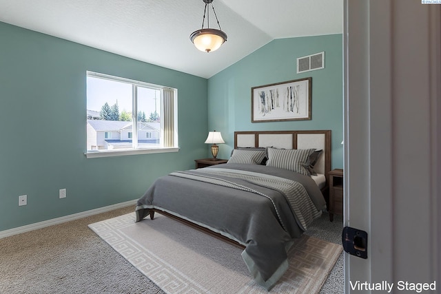 bedroom with carpet floors, baseboards, visible vents, and vaulted ceiling