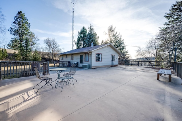 rear view of property with a patio, cooling unit, and outdoor dining space