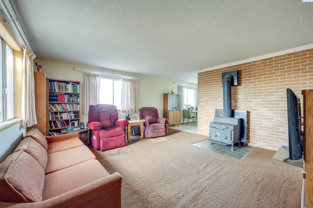 living area featuring a textured ceiling, carpet floors, and a wood stove